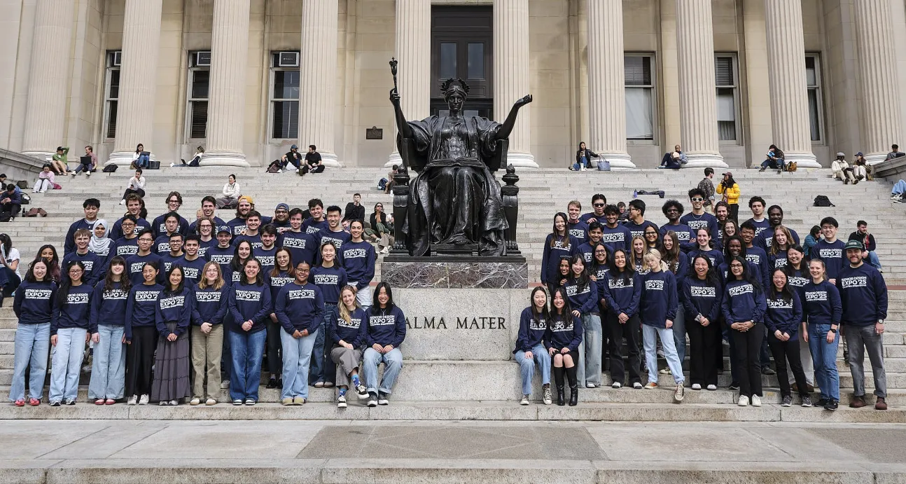Group of student surrounding Columbia's alma mater statue 