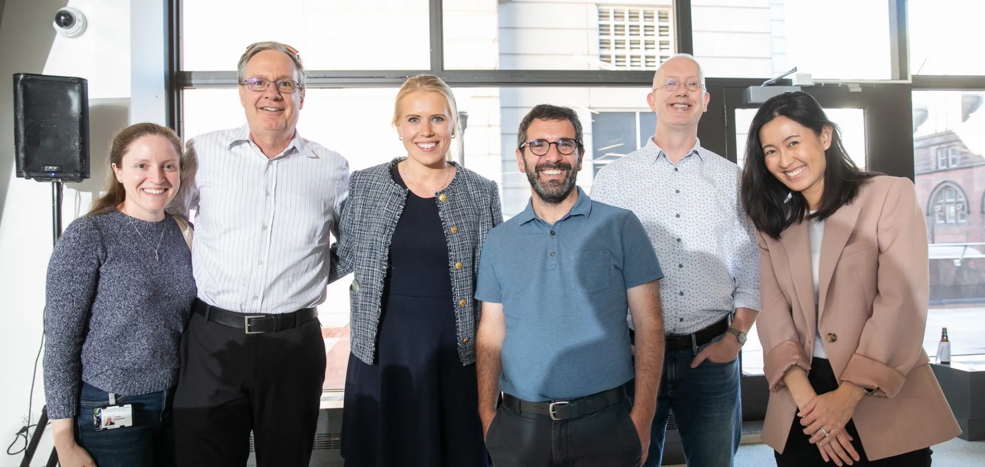 A group of six faculty members standing in Carleton Commons.